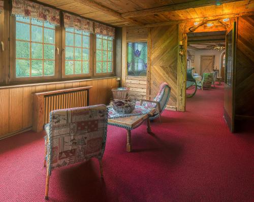 a room with a table and chairs in a building at Castel Madonna in San Martino di Castrozza