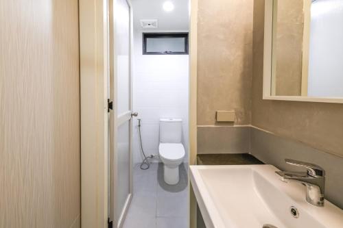 a bathroom with a white toilet and a sink at Hello my friend in Bang Bua Thong Railway Station