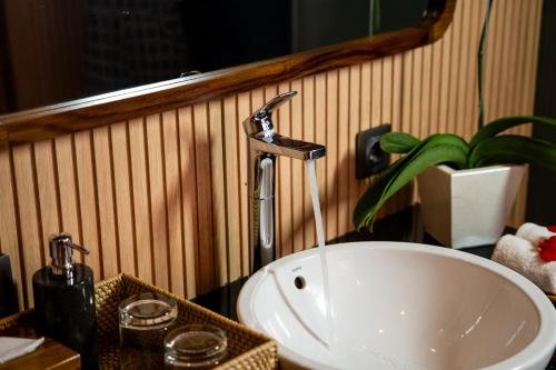 a sink in a bathroom with a faucet at Puri Andong Villa in Ubud