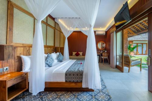 a bedroom with a bed with a canopy at Puri Andong Villa in Ubud