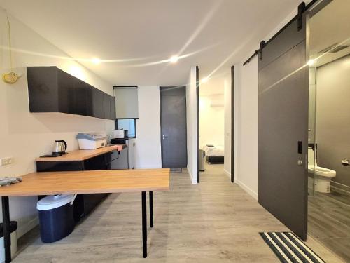 a kitchen with a wooden table in a room at The Modern A27 Hua-Hin Private Poolvilla from beach 3km in Hua Hin