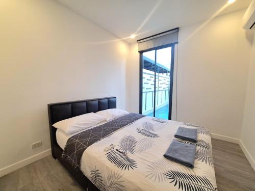 a bedroom with a bed and a large window at The Modern A27 Hua-Hin Private Poolvilla from beach 3km in Hua Hin