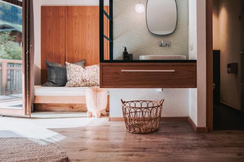 a bathroom with a sink and a mirror at SchönBerg hotel b&b in Rio Bianco