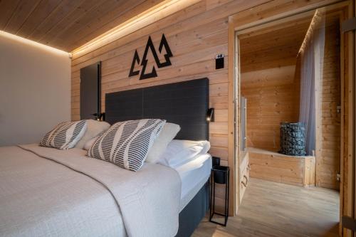 a bedroom with a bed with a black headboard at Apartmán STRÖMY Demänovská dolina in Liptovský Mikuláš