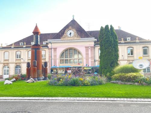 a large building with a clock on top of it at AbraCadabra Flat France Suisse in Saint-Louis