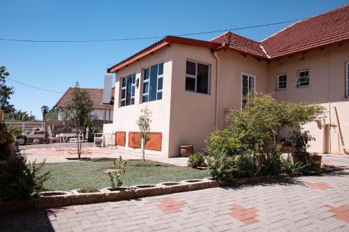 a house with a brick driveway in front of it at Emerald Bed&Breakfast in Windhoek
