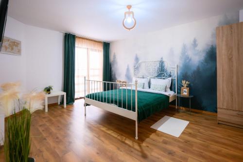 a bedroom with a bed with a green bedspread at Bran Mountain Living in Bran