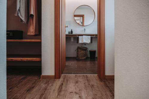 a bathroom with a sink and a mirror at SchönBerg hotel b&b in Rio Bianco