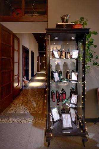 a display case in a hallway with bottles and lights at Le Maginot Relais in Castelvetro Piacentino