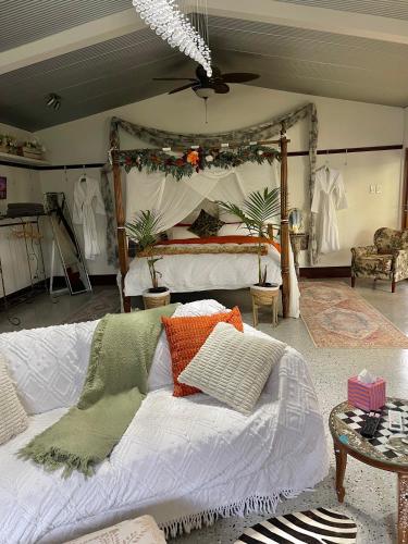 a bedroom with a bed with a canopy at Love at Sellicks Chills in Sellicks Hill