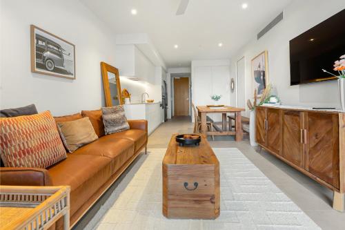 a living room with a couch and a coffee table at Bokarina Beach Apartments, an Ascend Collection Hotel in Bokarina