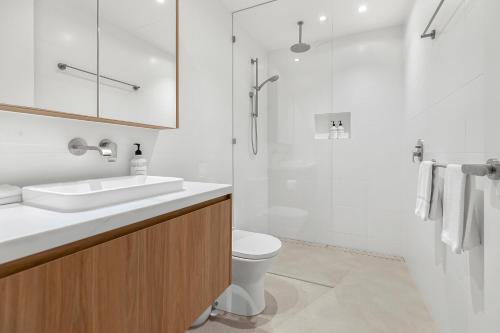 a bathroom with a sink and a toilet and a shower at Bokarina Beach Apartments, an Ascend Collection Hotel in Bokarina