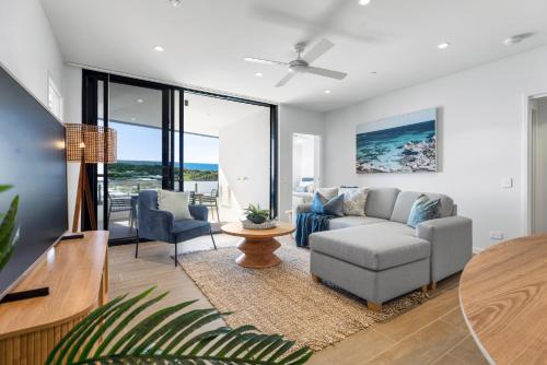 a living room with a couch and a table at Bokarina Beach Apartments, an Ascend Collection Hotel in Bokarina