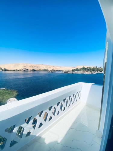 a balcony with a view of the water at Nile View Guest House in Aswan