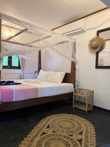 a bedroom with a bed with a canopy at Jungle Nook Hiriketiya in Hiriketiya
