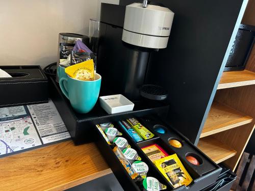 a drawer filled with food and a coffee maker at Hotel No5, Beachfront with Free Private Car Park in Llandudno