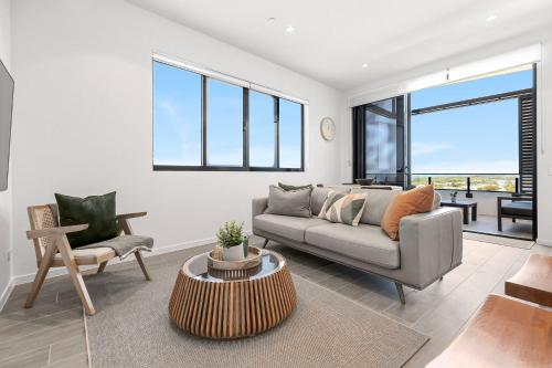 a living room with a couch and a table at Bokarina Beach Apartments, an Ascend Collection Hotel in Bokarina