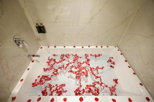 a white bath tub covered in red blood at Pride Premier Solitaire in Dehradun