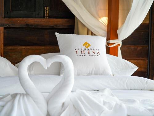 two white swans making a heart on a bed at RoomQuest THEVA Resort Koh Samui in Koh Samui 