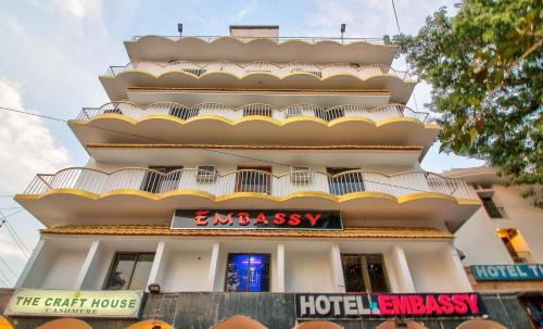 a large white building with a hotel sign on it at Hotel O Embassy in Bodh Gaya