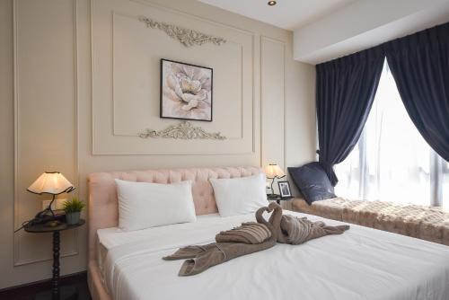 a stuffed animal on a bed in a bedroom at R&F Princess Cove by Nest Home at Johor Bahru in Johor Bahru
