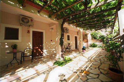 a courtyard of a house with a pergola at Christianna studios in Nikiana