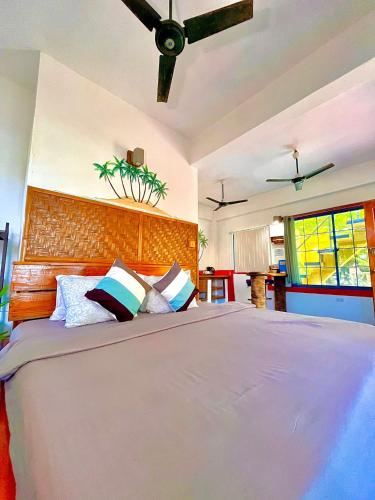 a bedroom with a large bed in a room at Apo Diver Beach Resort in San Juan
