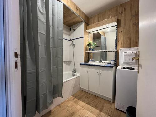 a bathroom with a shower and a sink and a refrigerator at Appartement lumineux avec piscine et parking à Évian - FR-1-498-109 in Évian-les-Bains