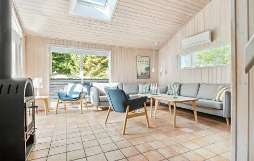 a living room with a couch and chairs and a table at Gorgeous Home In Ålbæk With Sauna in Ålbæk