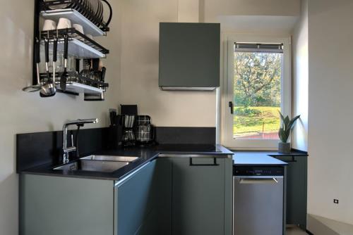 a small kitchen with a sink and a window at Luca's home over the Rose Garden in Florence