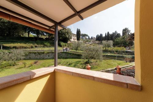 a view of a garden from a window of a house at Luca's home over the Rose Garden in Florence