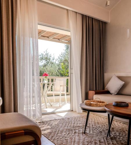a living room with a couch and a table at Pilos Suites in Turunc