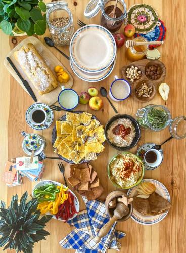 a wooden table with many plates of food on it at Trilli EcoBnB in Carloforte