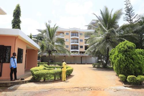 a man and a woman standing in front of a building at Residence La Marina in Yaoundé