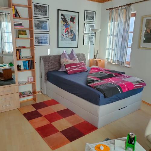 a bedroom with a bed and a rug at Südpfalz in Barbelroth