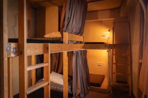 a couple of bunk beds in a room at Local Knot Backpackers in Nagano