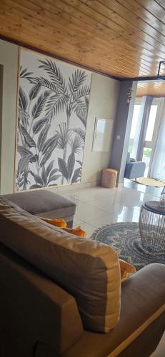 a living room with a couch and a wall at lilie97418 in La Plaine des Cafres