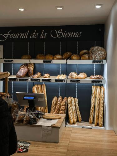 a bakery filled with lots of different types of bread at La Maison Gavraise in Gavray