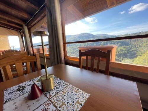 a dining room with a table and a large window at Palazzo del Baglivo Cilento Hotel & Spa in Sessa Cilento