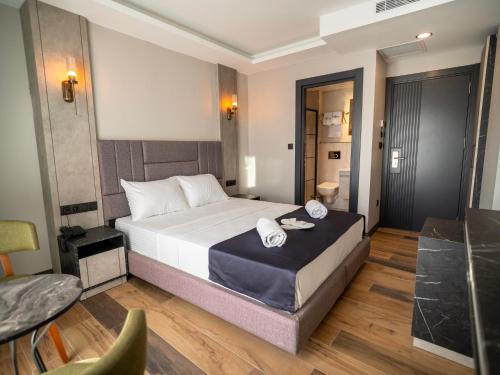 a bedroom with a bed with two towels on it at Comfort Point Three Hotel in Istanbul