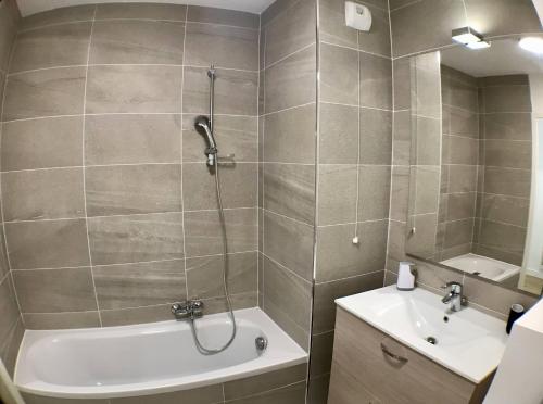 a bathroom with a shower and a tub and a sink at Auron- Magnifique 3p neuf in Saint-Étienne-de-Tinée
