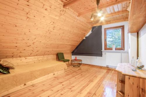 a large room with a bed and a window at Rustykalny domek pod Ślężą in Sulistrowiczki