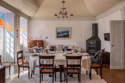 a dining room with a table and a couch at Manteigas Lovers in Manteigas