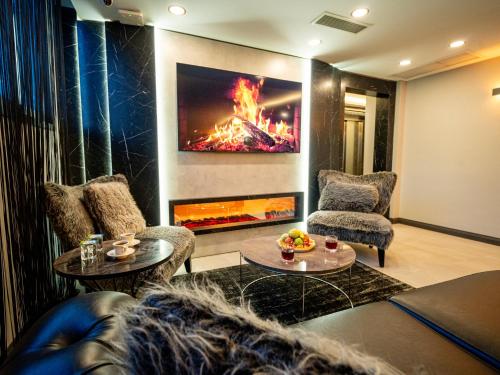 a living room with two couches and a fireplace at Comfort Point Three Hotel in Istanbul