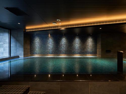 a swimming pool in a building at Princess Garden Hotel in Nagoya