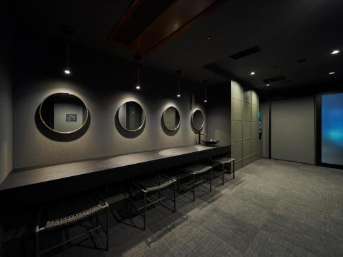 a room with a row of mirrors on the wall at Princess Garden Hotel in Nagoya