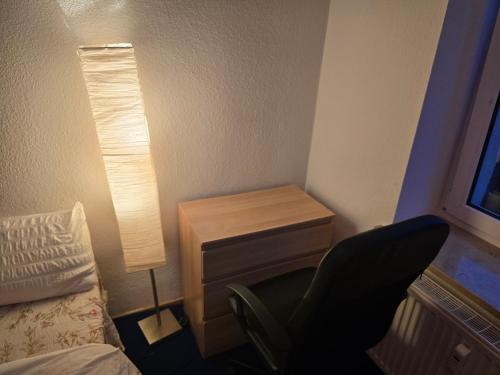 a bedroom with a desk and a chair next to a bed at Cozy & queit Stay with Marcbride in Leipzig