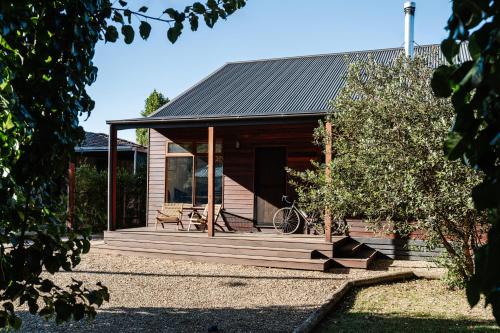 a house with a wooden porch with a bike on it at The Wooden House in Bright
