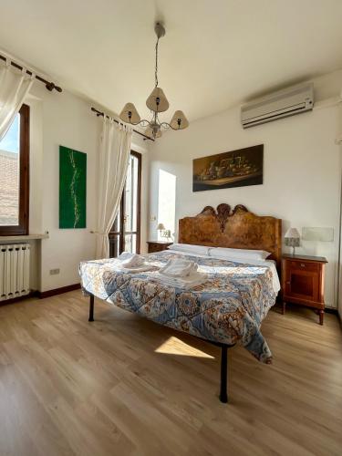 a bedroom with a large bed in a room at Dimora '800 in Ferrara