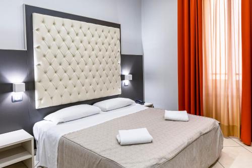 a bedroom with a bed with two towels on it at Hotel Demo' in Milan